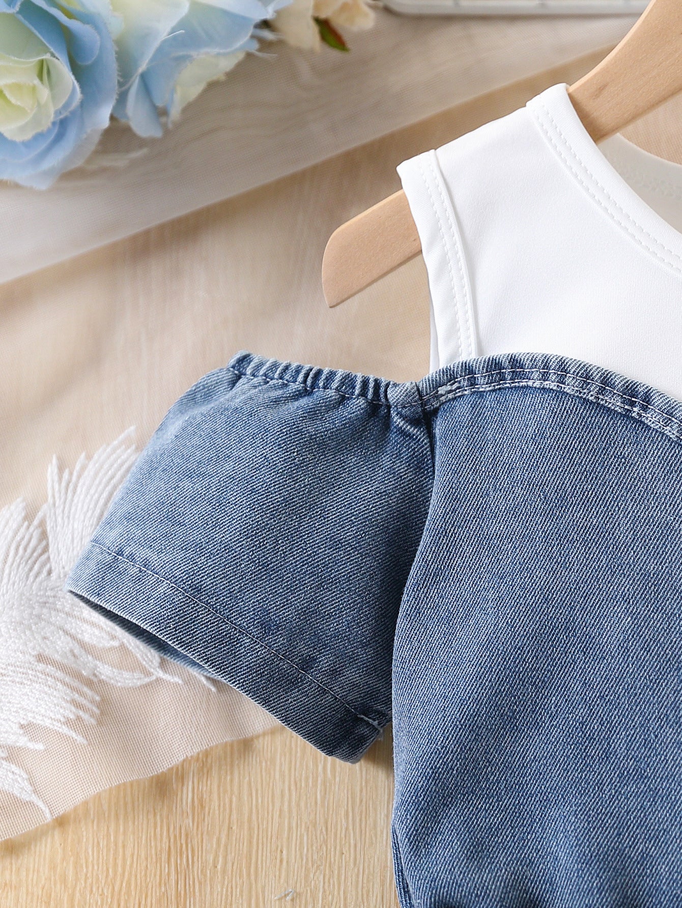 Close up of white patchwork denim panels on the girls' dress