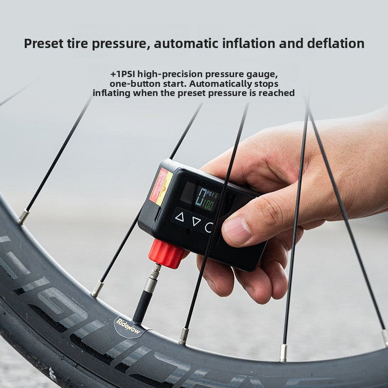 Hand holding the black electric bicycle air pump connected to a bicycle valve on a wheel, Black option