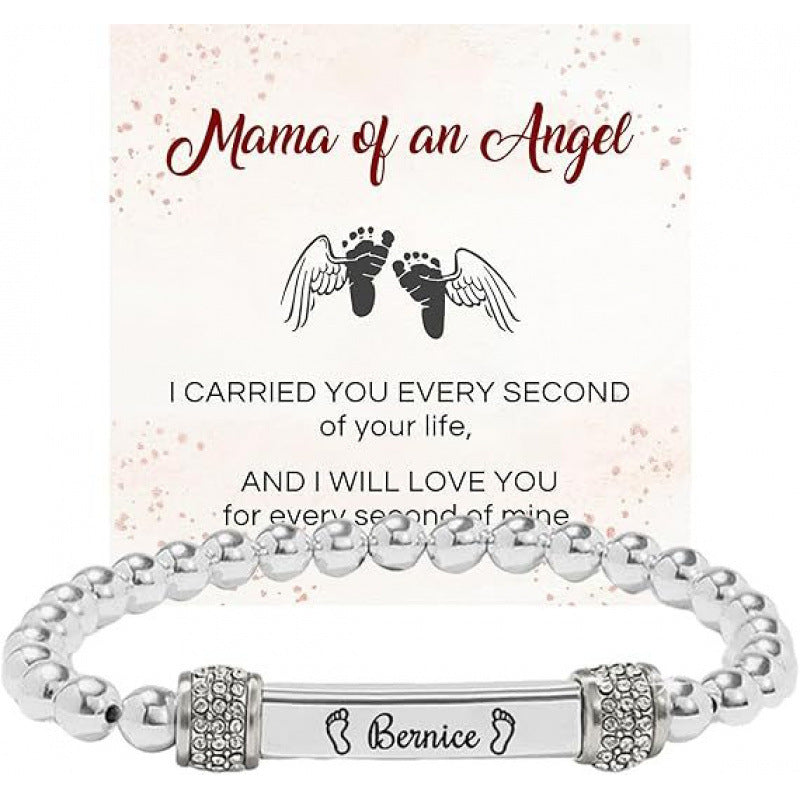 Silver bead stainless steel bracelet with an engraved bar and a footprint accent