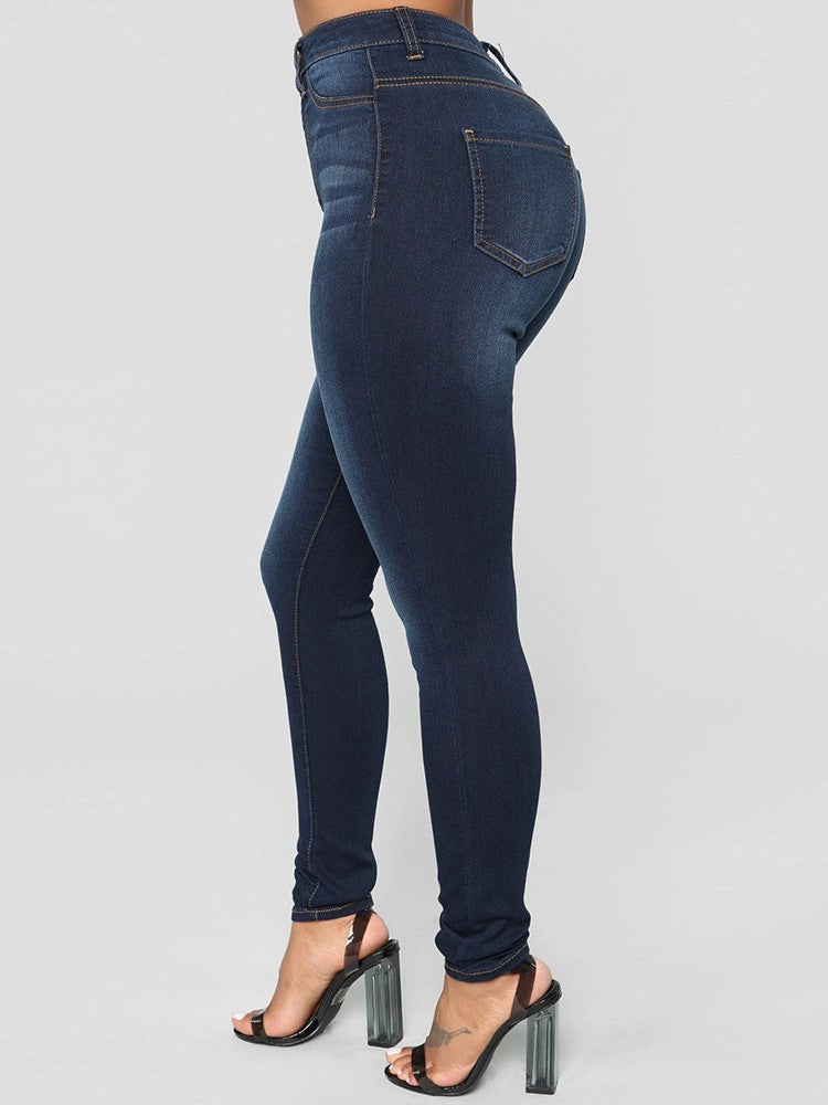 Dark blue stretch skinny jeans, side view of the contoured hip and seat on model