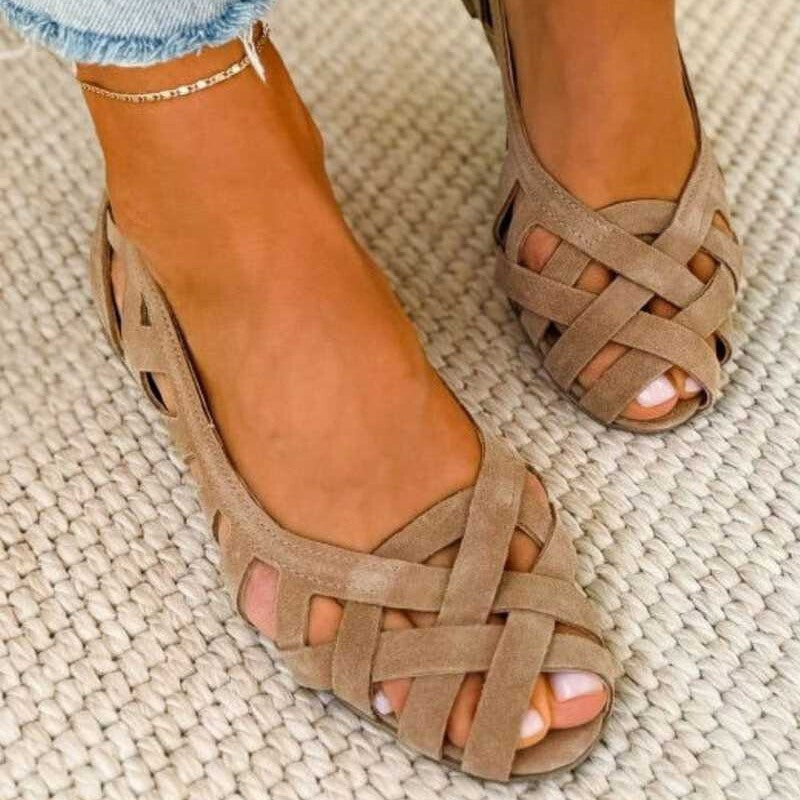 Cut out suede sandal with open sides and a closed low heel