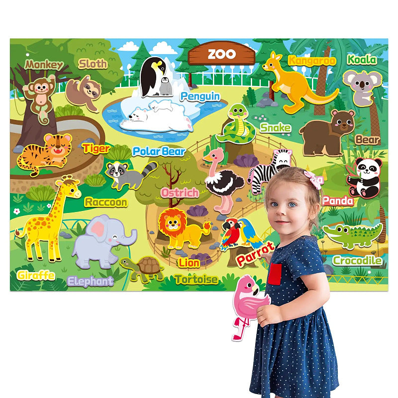 Girl beside a zoo and world animal felt story board covered in labelled felt animal pieces
