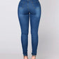 Light blue stretch skinny jeans, back view showing back pockets and stitching on model