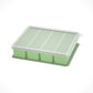 Flexible platinum silicone ice cube tray shown stacked in a freezer for portioning purees