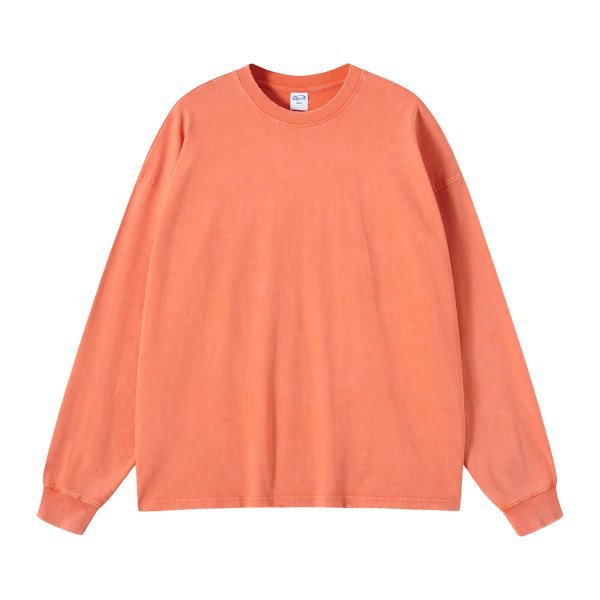 Washed heavyweight oversized long sleeve tee in orange hanging from the front