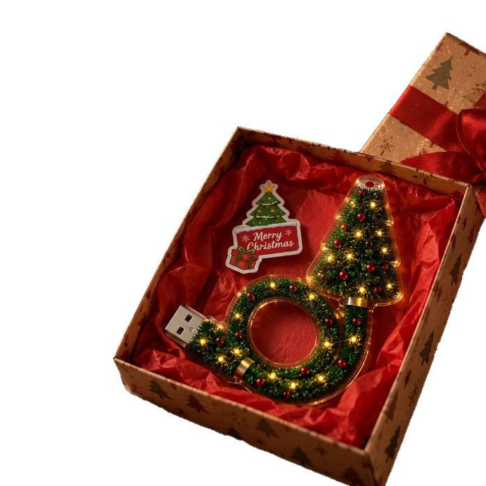 Tree shaped LED Christmas light and wreath shaped USB loop in an open gift box on a white background