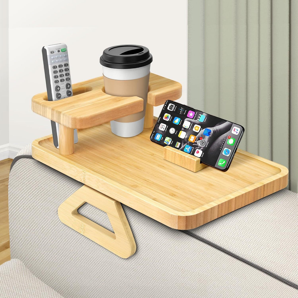Bamboo sofa arm tray with raised shelf, cup holder and phone slot on a couch arm