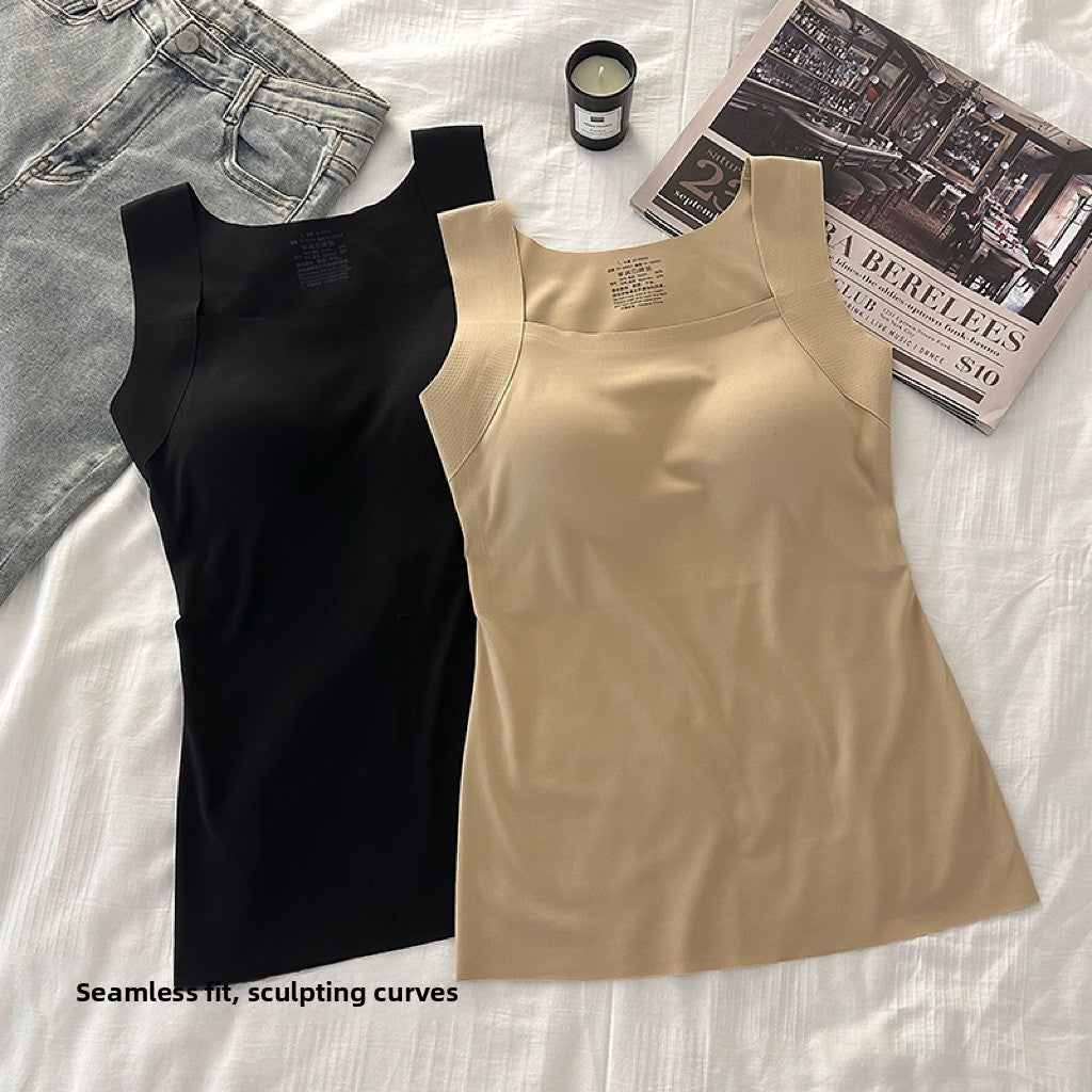 Black and nude seamless square neck tank tops flat lay on white bedding with jeans and a candle