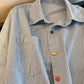 Blue striped long sleeve shirt styled loose over jeans for a casual look
