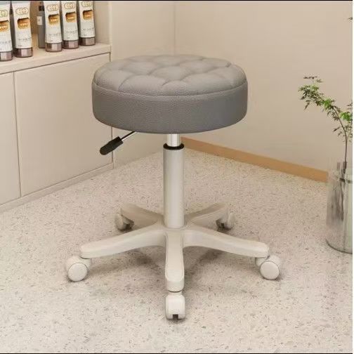 Black salon styling chair with silver metal armrests on a brushed silver square base
