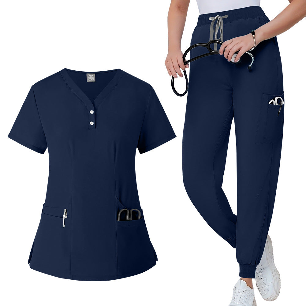 Womens V neck scrub top in deep blue shown flat to display the placket and side pockets