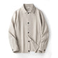 Close detail of the linen jacket button and front placket on the lapel front