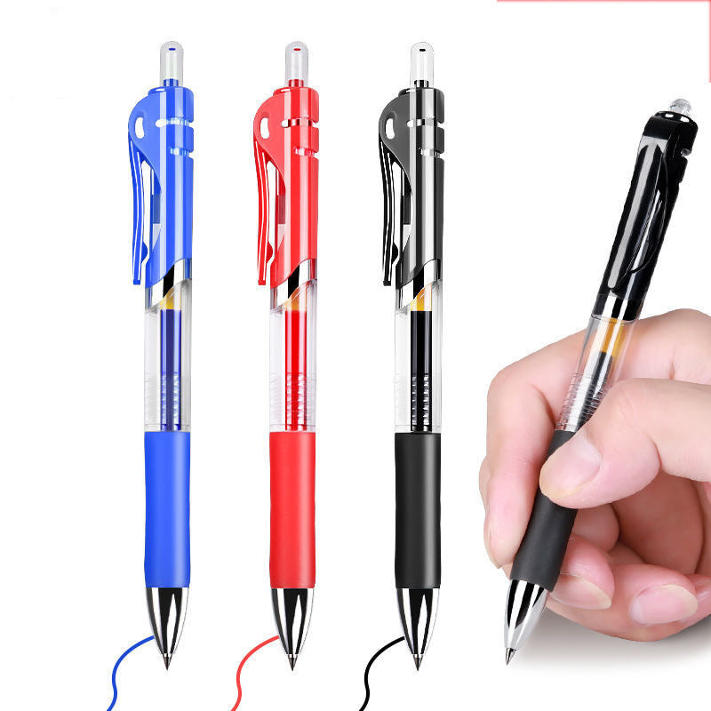Blue, red and black retractable gel pens beside a hand writing a line with a black pen