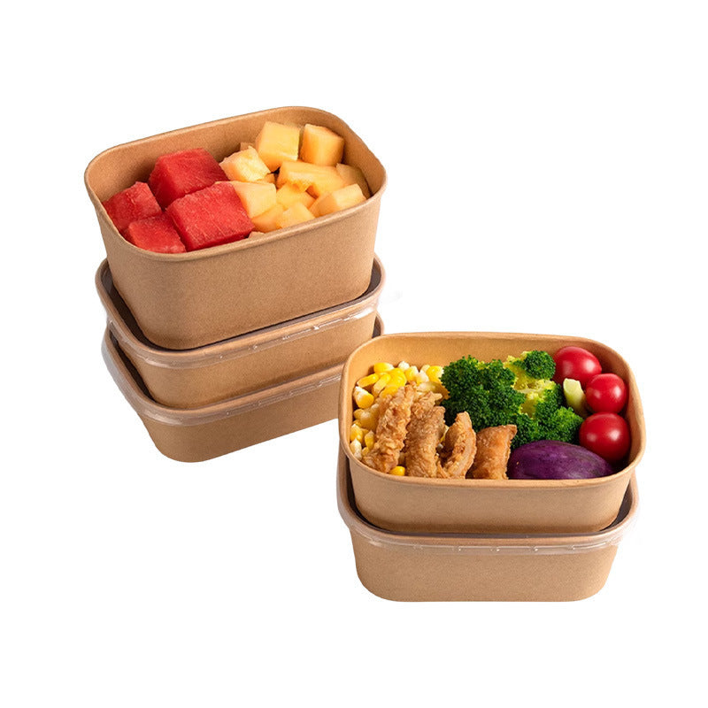 Stacked brown kraft paper lunch boxes filled with fruit, salad and fried food, lids on