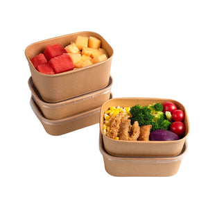 Stacked brown kraft paper lunch boxes filled with fruit, salad and fried food, lids on