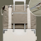 Weekender bag rear band slid over a wheeled suitcase handle