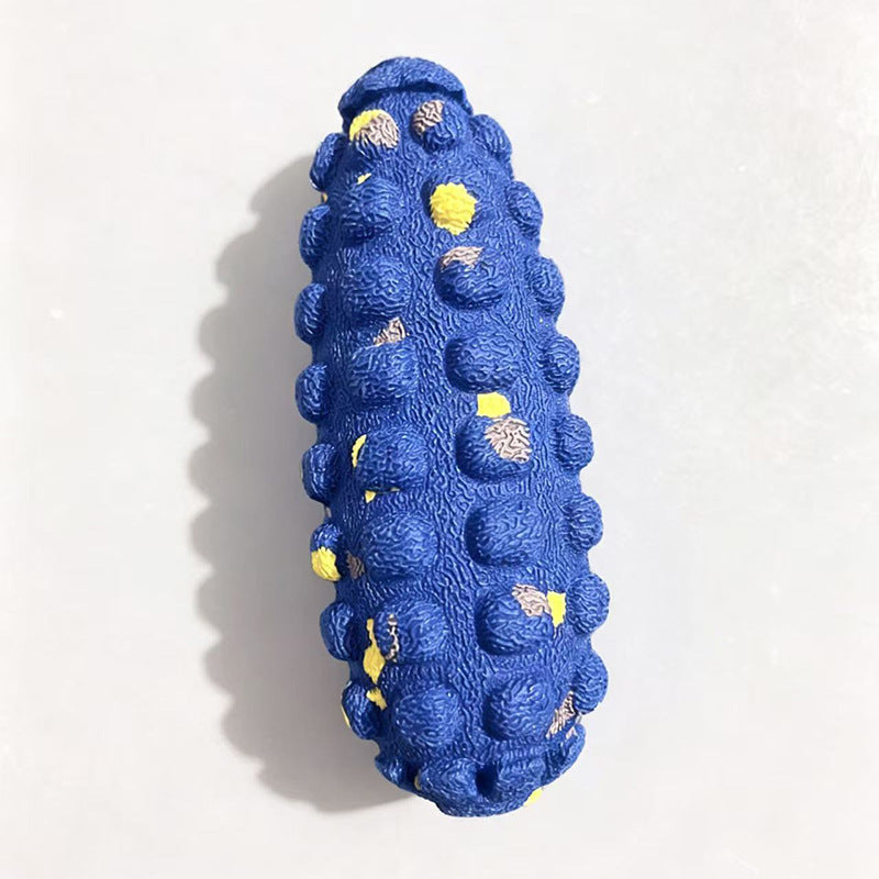 Blue bumpy corn cob shaped dog toy with small yellow flecks on a white background, option photo