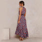 Red and purple floral halter neck sleeveless tiered swing maxi dress worn by a model