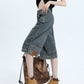 High-waist denim shorts, side profile showing the leg and hem