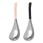 Two stainless steel facial massage globes with pink and black silicone handles on white