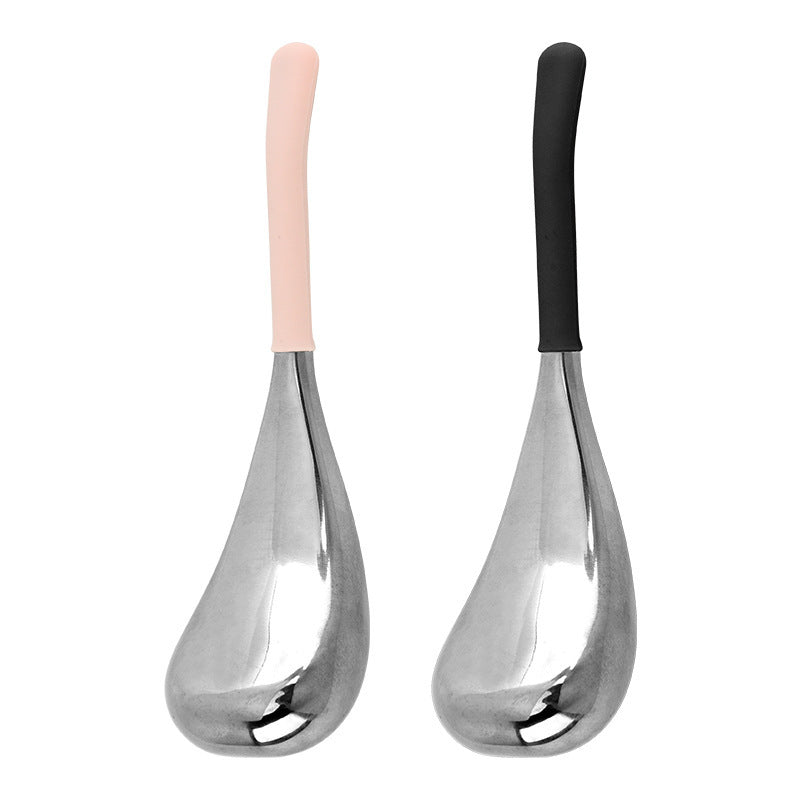 Two stainless steel facial massage globes with pink and black silicone handles on white
