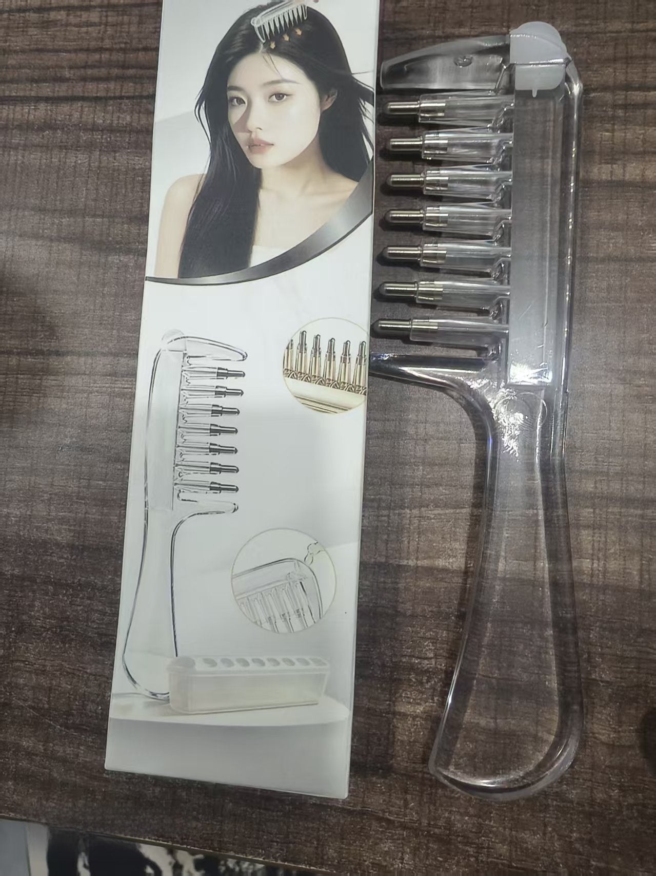 Transparent liquid guide comb resting flat to show the wide teeth and hollow tubes