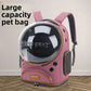 Plum pink space capsule cat carrier backpack with large clear dome, vent holes and tan piping on a wooden floor