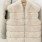 Beige White tiered vegan fur sleeveless vest on a hanger showing six horizontal fur tiers