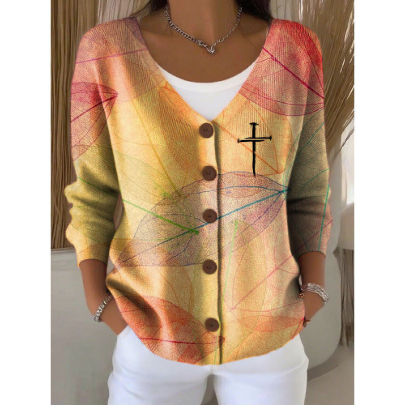 Women's V neck button front knit cardigan in the Autumn Leaves print worn open over a white top