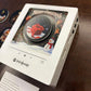 Close view of the white music player frame with a Merry Christmas red gift and snowman scene under a black disc
