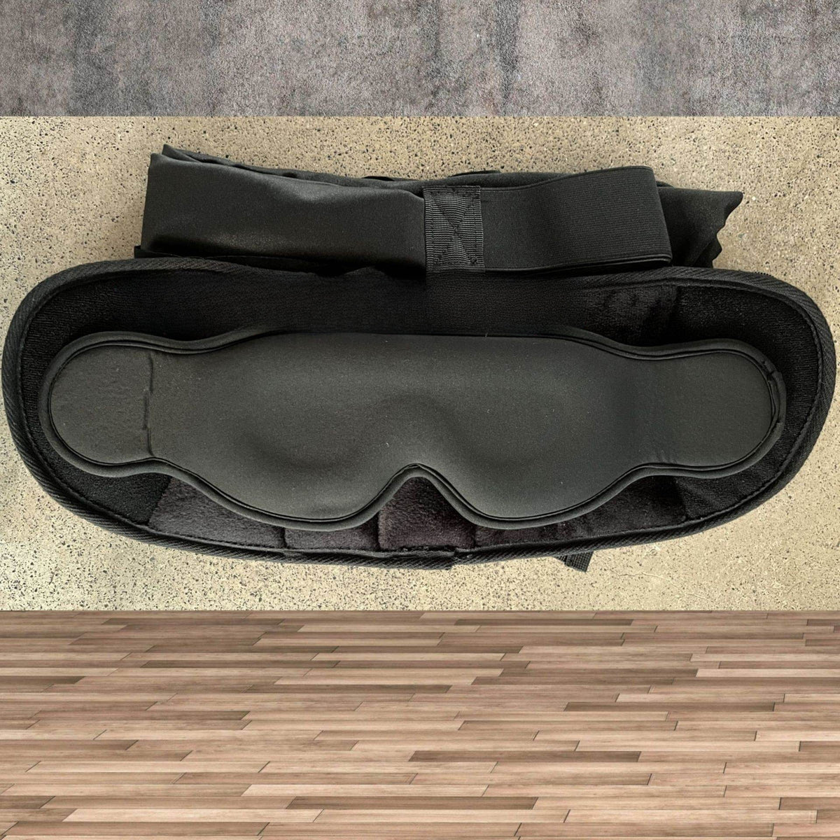 Black 3D eye mask resting on a black pillow with a strap, Pillow Zip Eye Mask 3D Armrest option