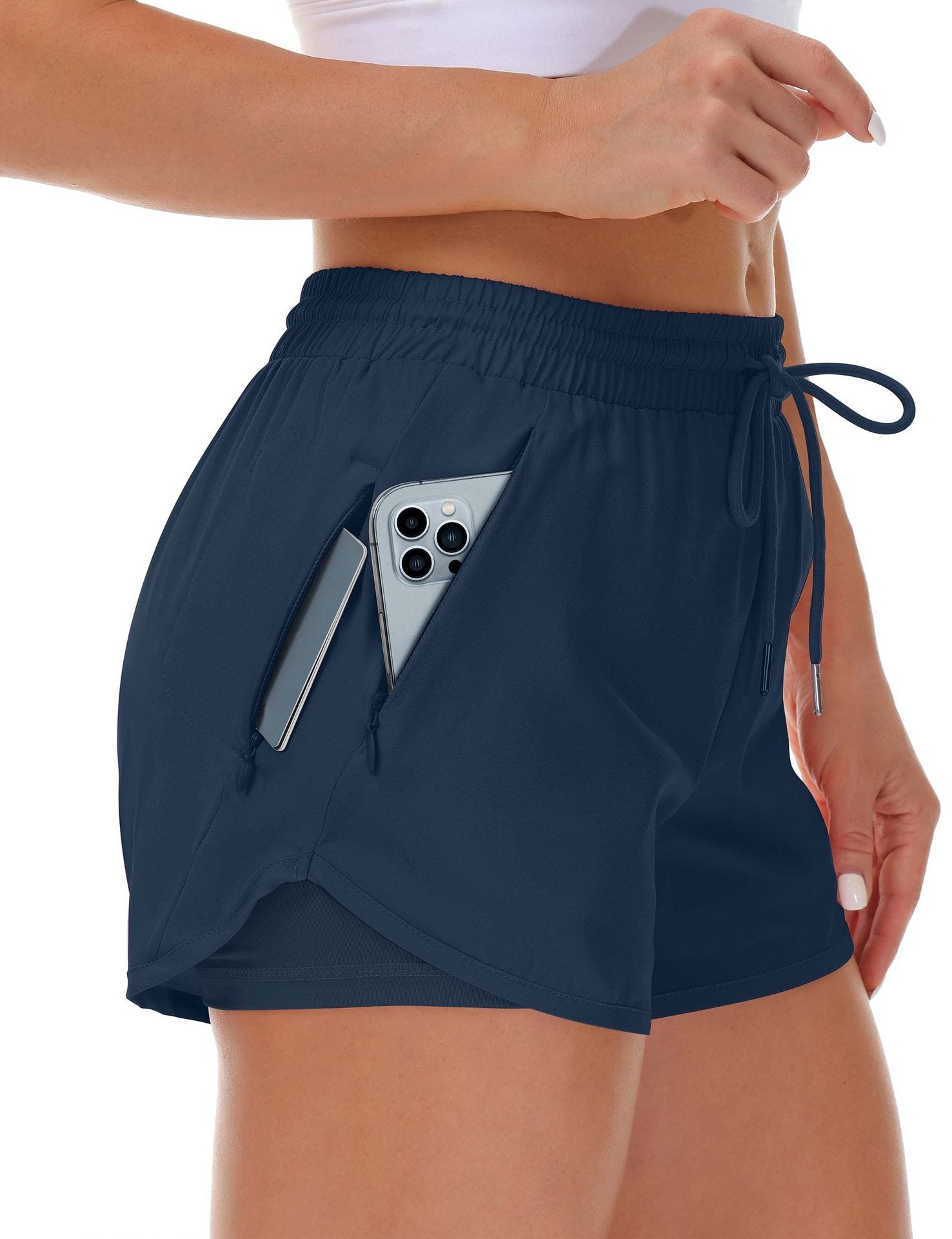 A red side view of womens running shorts showing the phone pocket holding a phone