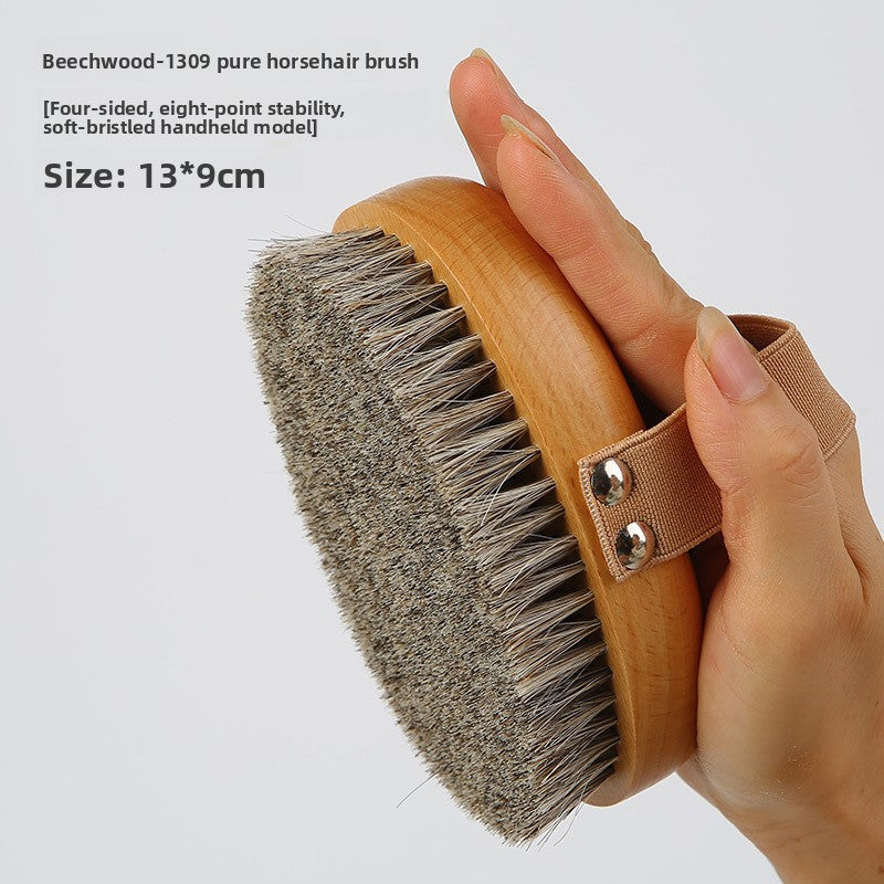 Hand holding the Beech 1309 pure horsehair body brush, soft bristled model, with a caption of 13 by 9 cm