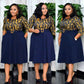Navy printed bodice belted pleated swing midi dress shown on a standing model, front view
