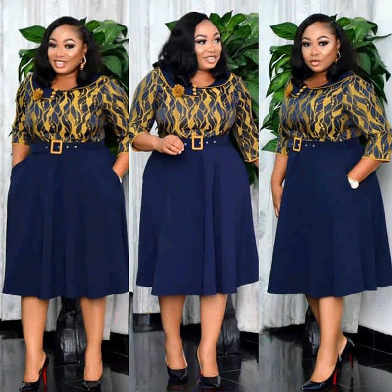 Navy printed bodice belted pleated swing midi dress shown on a standing model, front view