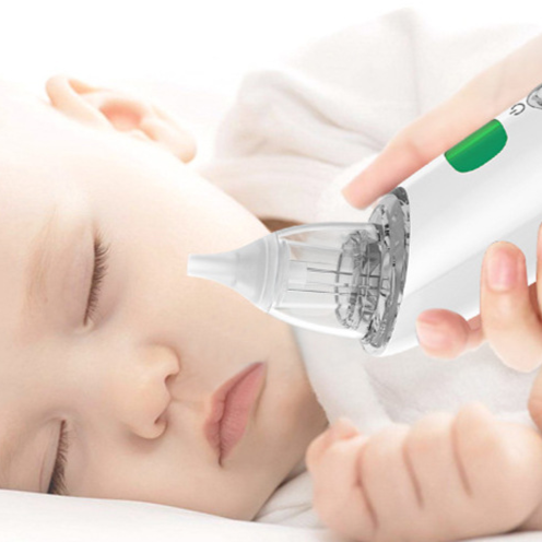 Sleeping baby with a parent holding the white electric nasal aspirator near the nose