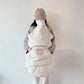 Snap buttons along the body that adjust the length of the baby cape