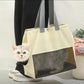 Beige cat carrier tote with a cat poking its head out the side opening and the body behind the mesh