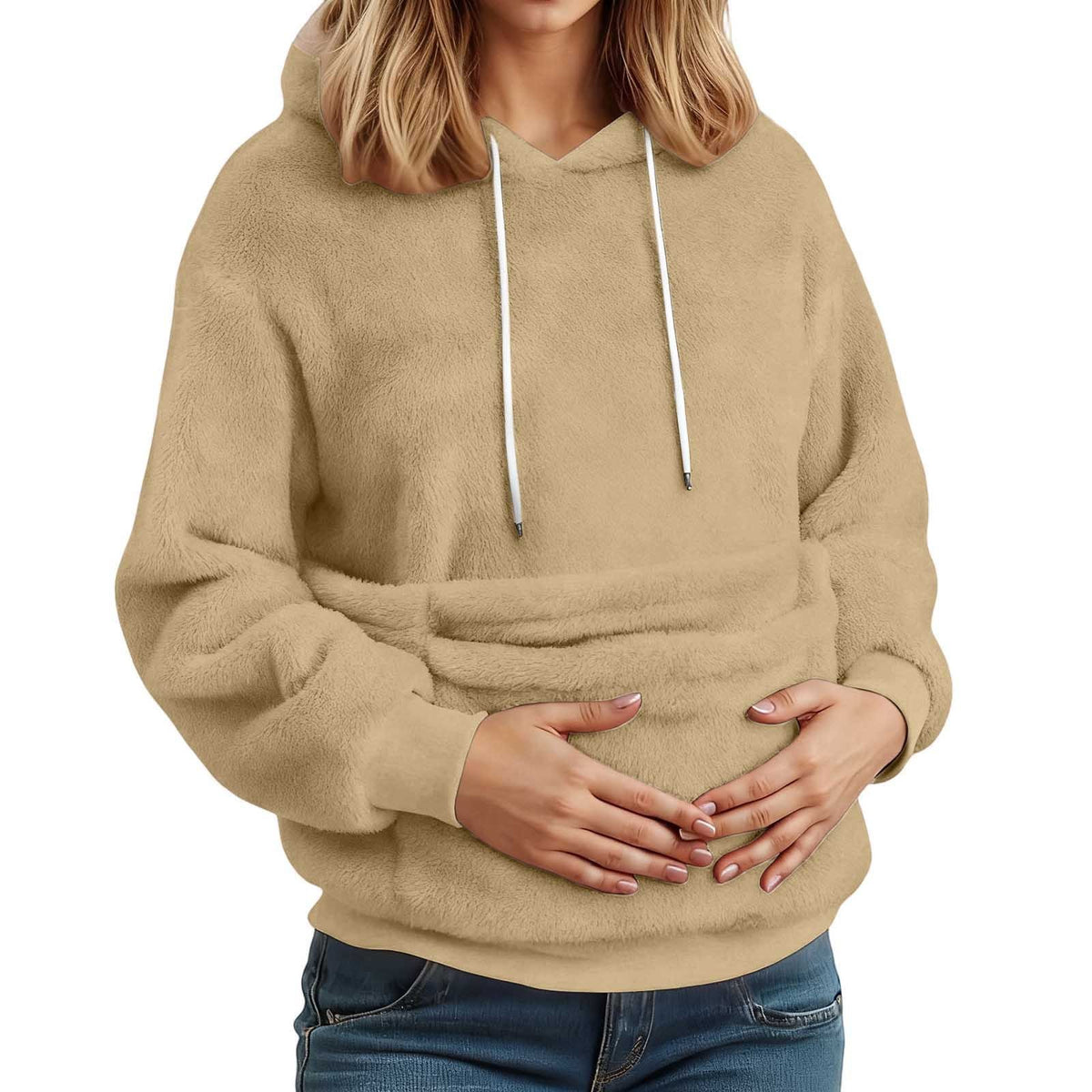 Sand plush fleece hoodie on a model with both hands in the large front pocket