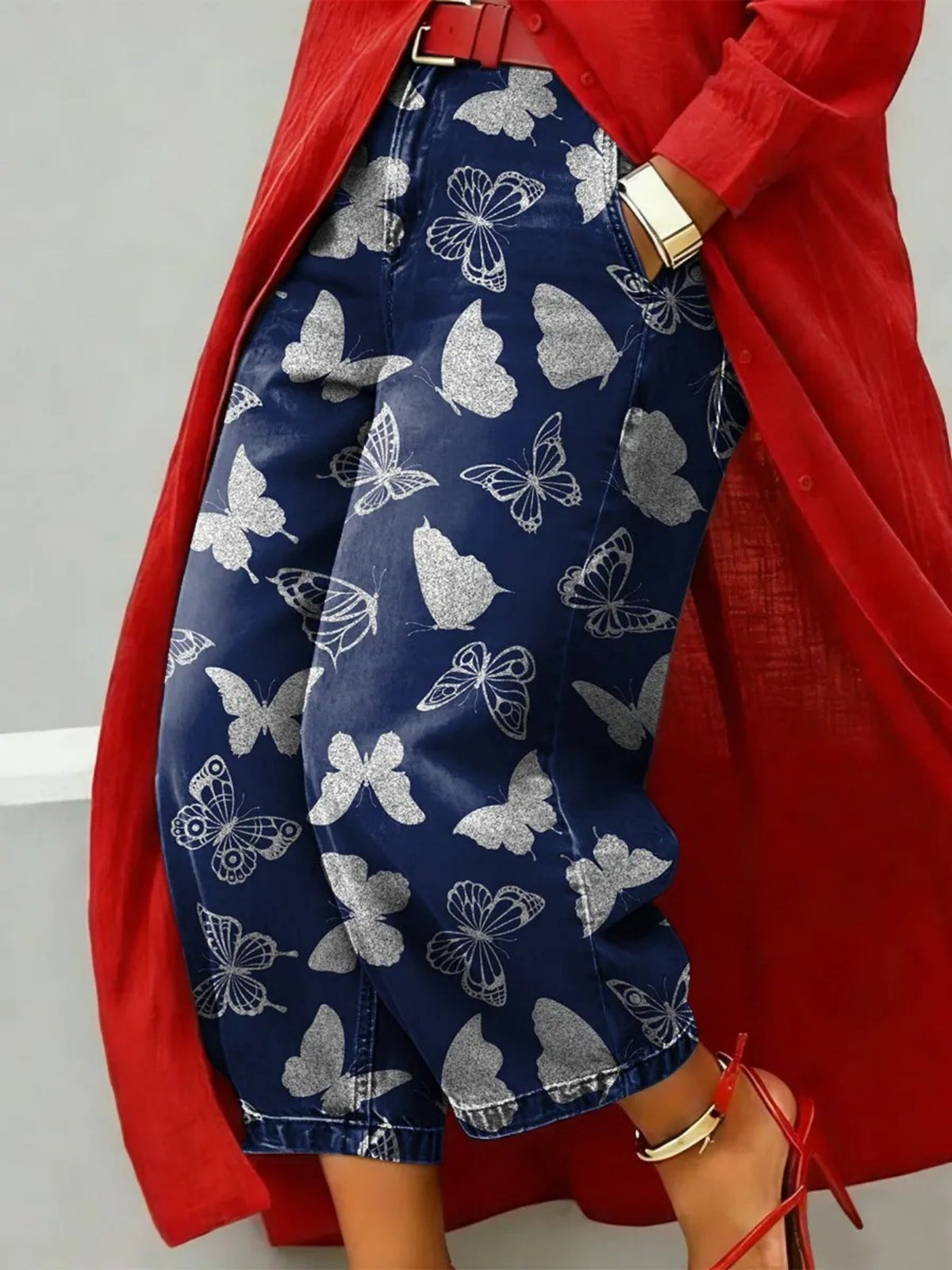 Wide leg cropped navy denim jeans with silver white butterfly print, red coat and heels