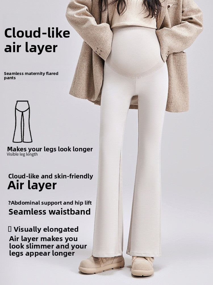Maternity bell-bottom pants in beige on a pregnant model with a seamless high-waist belly panel