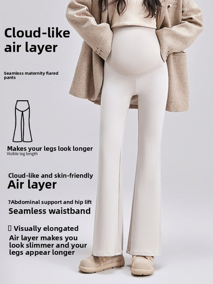 Maternity bell-bottom pants in beige on a pregnant model with a seamless high-waist belly panel