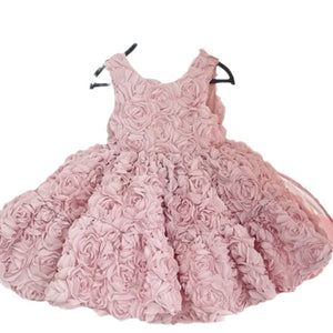Pink princess party dress shown close up on its 3D rosette fabric and gathered waist