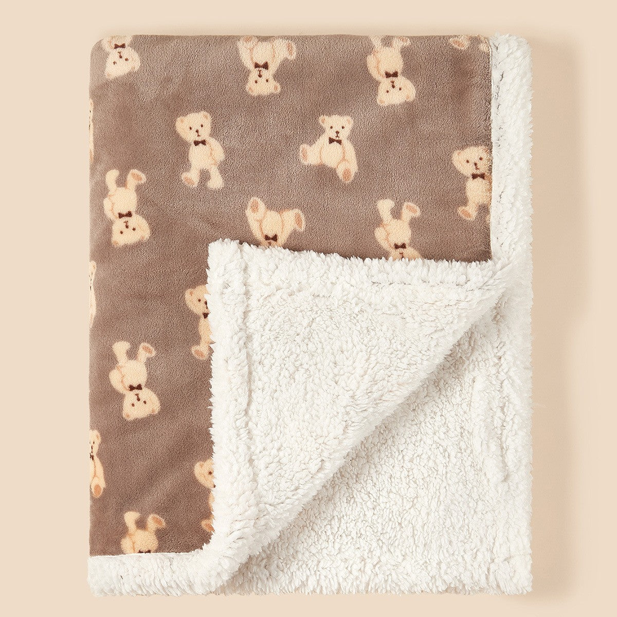 Baby tucked under soft flannel cartoon blanket during a cozy nap