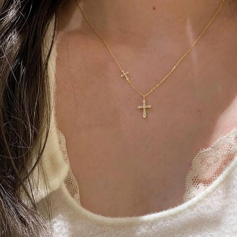 Close up of the larger cross pendant paved with tiny cubic zirconia in sterling silver