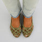 Close view of the criss cross woven upper on a womens flat sandal in matte PU straps
