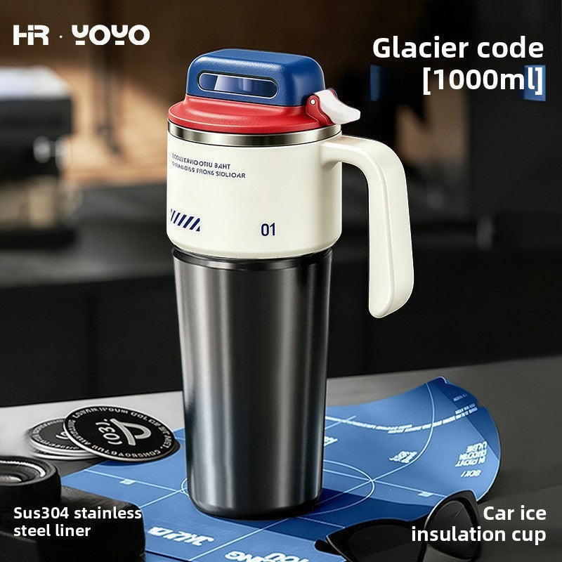 Cream and red 1000ml insulated travel mug with flip lid and side handle on a kitchen counter