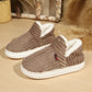 Soft fleece lined slip on slipper shown on a wooden floor for a cozy home look