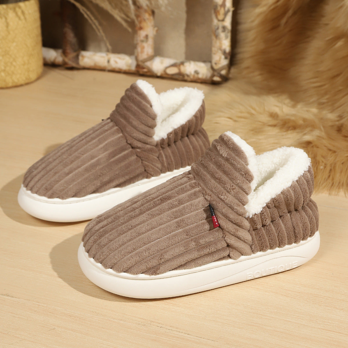 Soft fleece lined slip on slipper shown on a wooden floor for a cozy home look