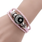 Pink braided cord bracelet on a wrist with a crescent moon and star cabochon between silver tone beads